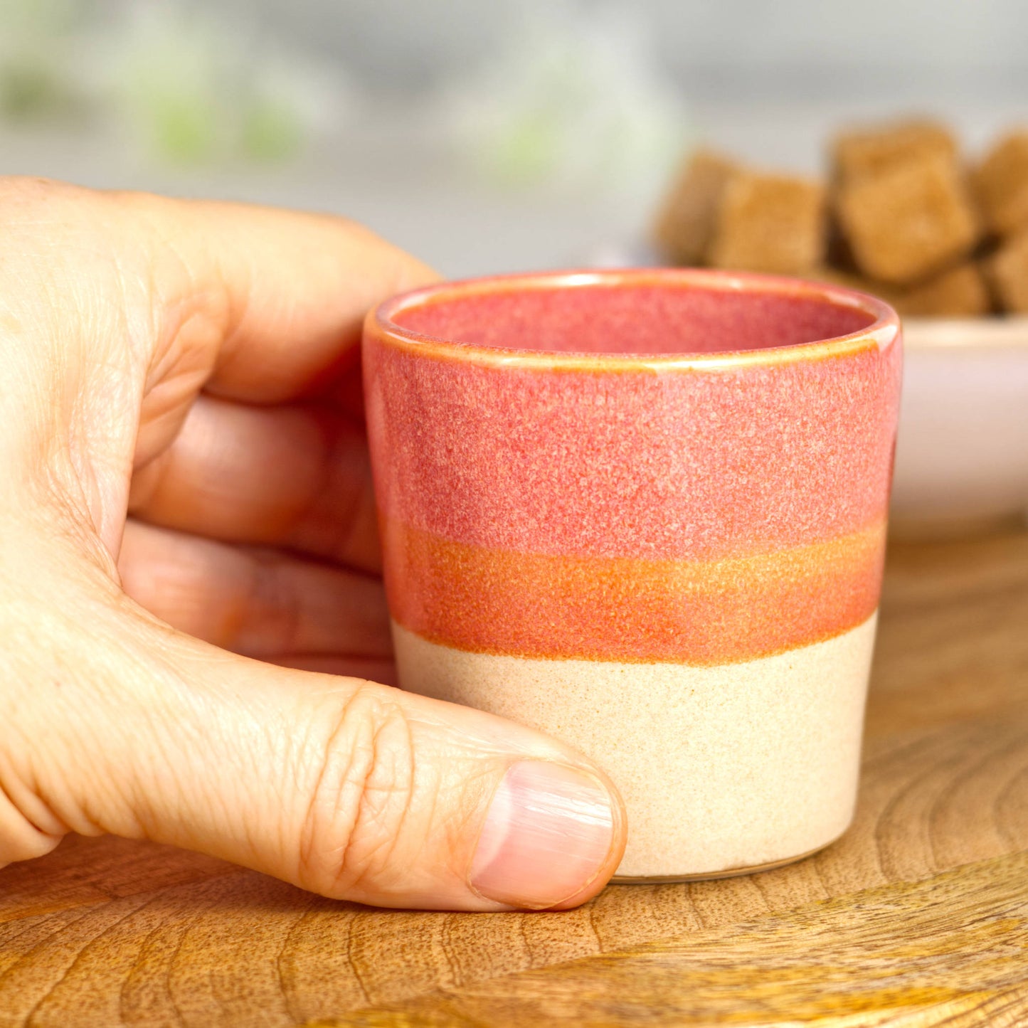 Wheel-thrown stoneware espresso cup in hand showing small size and balanced form