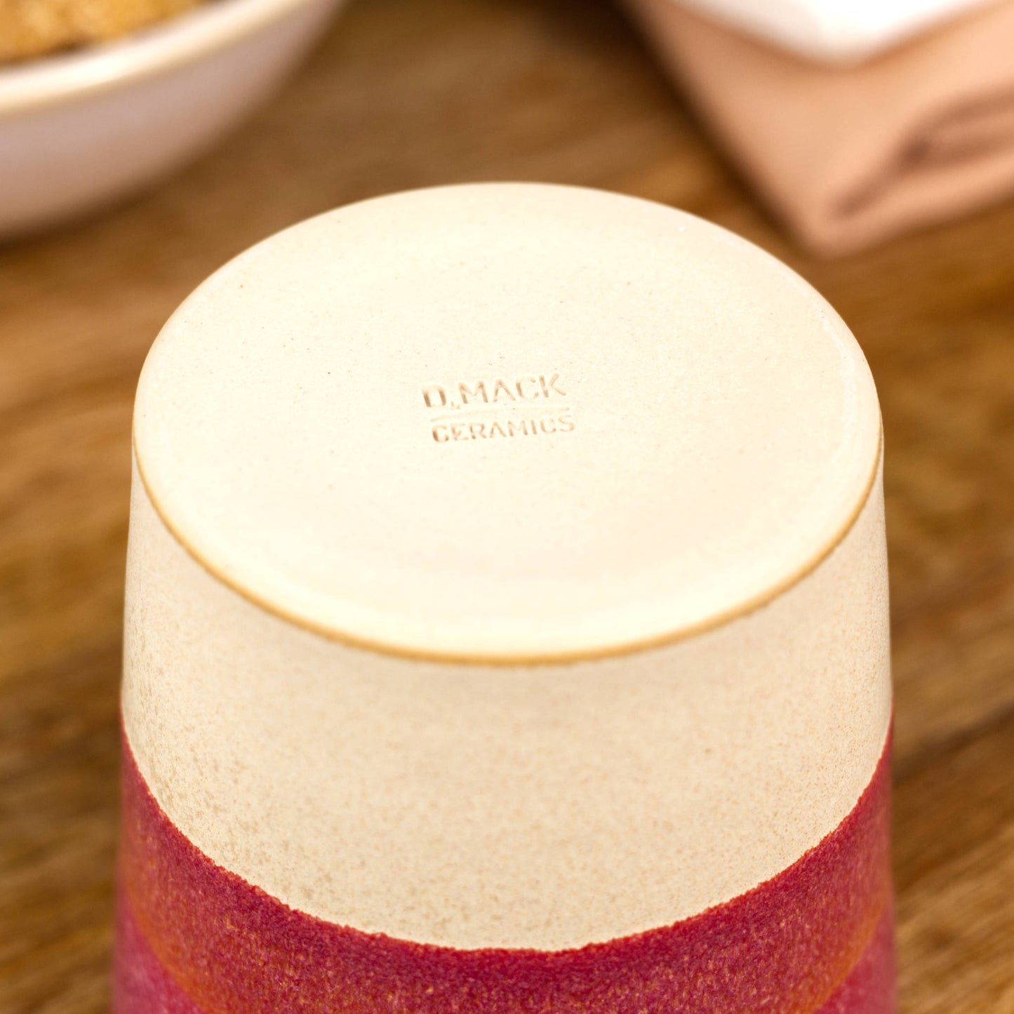 Base of espresso cup with burnished smooth clay and maker’s mark from British ceramics studio