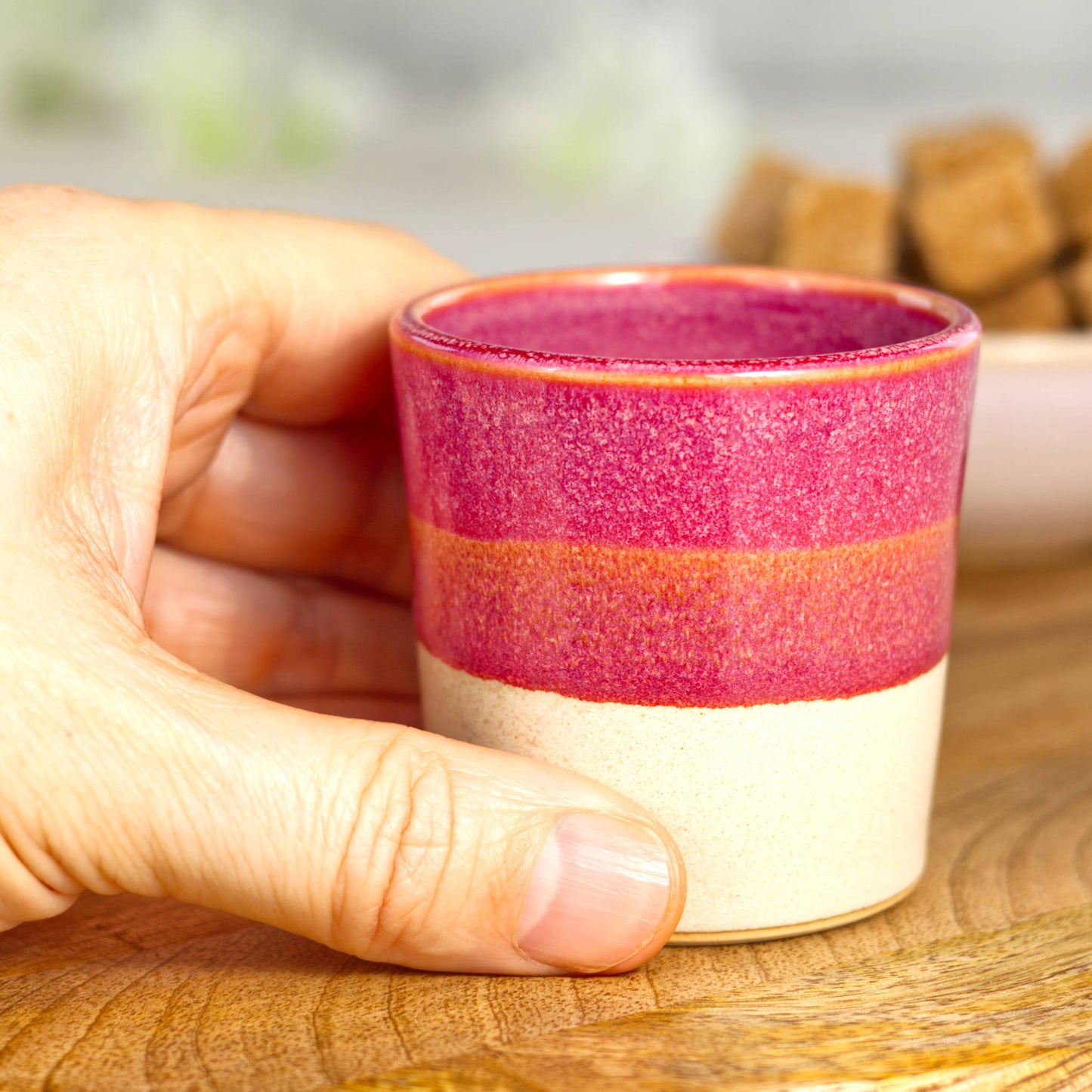 Wheel-thrown stoneware espresso cup in hand showing compact form and friendly feel