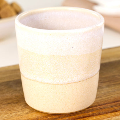 Close up of the two overlapping glazes on this espresso tumbler made with stoneware clay