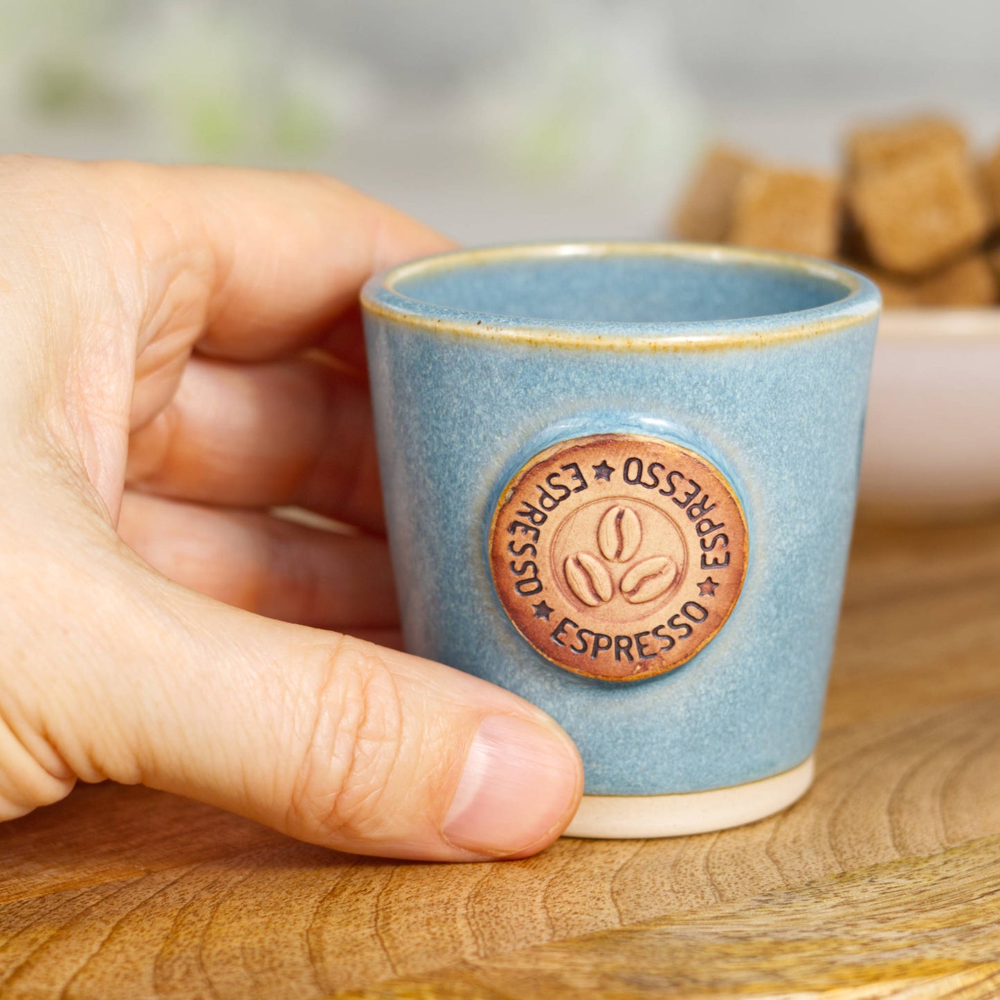 Wheel-thrown stoneware espresso cup held in hand showing size and barista espresso scale