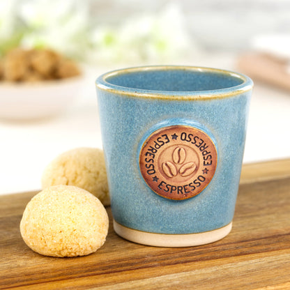 Coastal Blue ceramic espresso cup with coffee bean motif on wooden board with amaretti biscuits