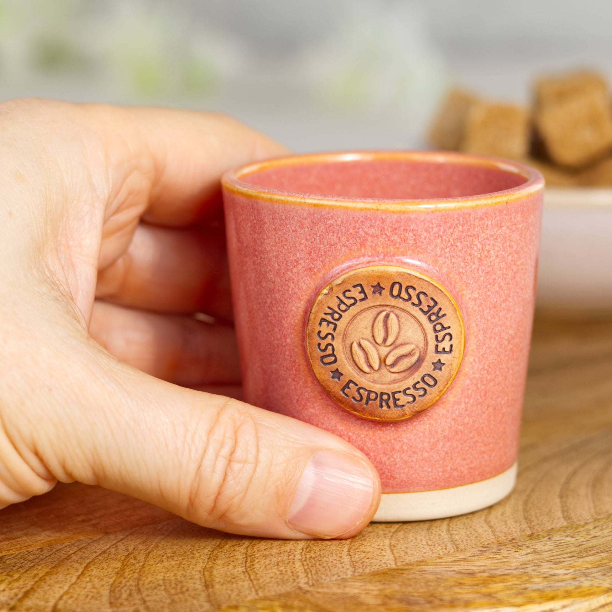 Wheel-thrown stoneware espresso cup in hand showing compact espresso size and form