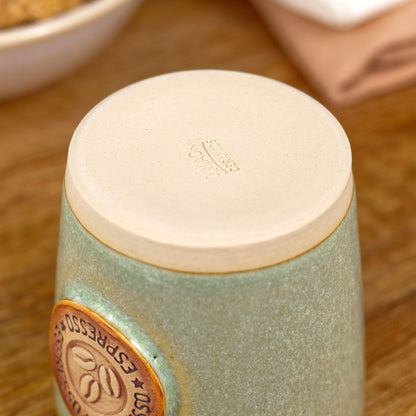 Base of espresso cup with burnished smooth clay and maker’s mark from Sussex pottery studio