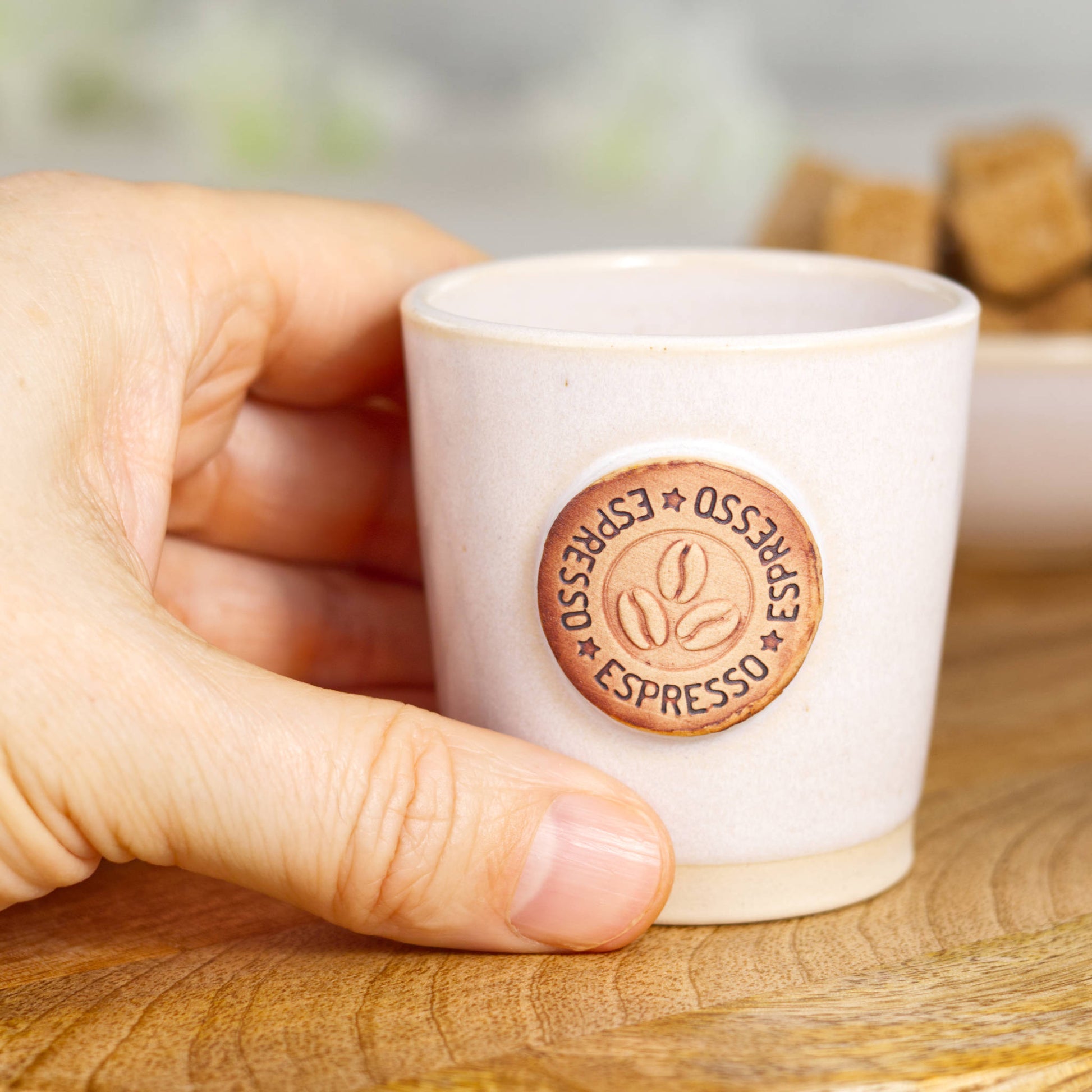 Wheel-thrown stoneware espresso cup in hand showing classic espresso size and simple form