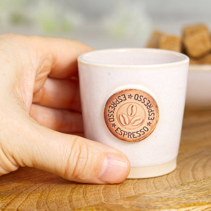 Wheel-thrown stoneware espresso cup in hand showing classic espresso size and simple form