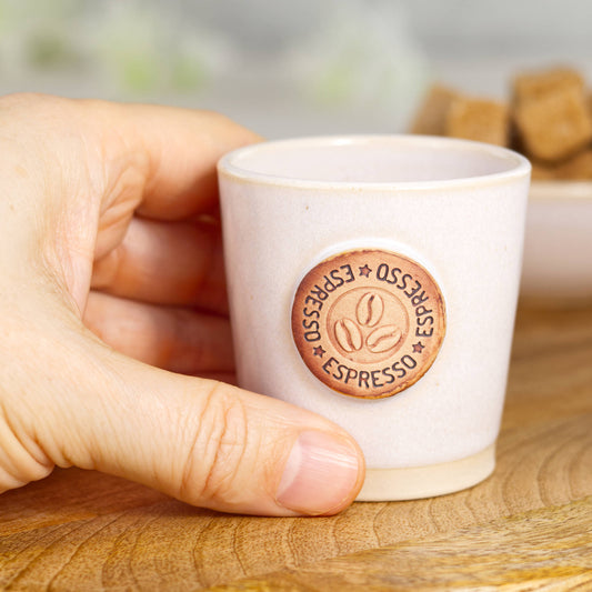 Wheel-thrown stoneware espresso cup in hand showing classic espresso size and simple form