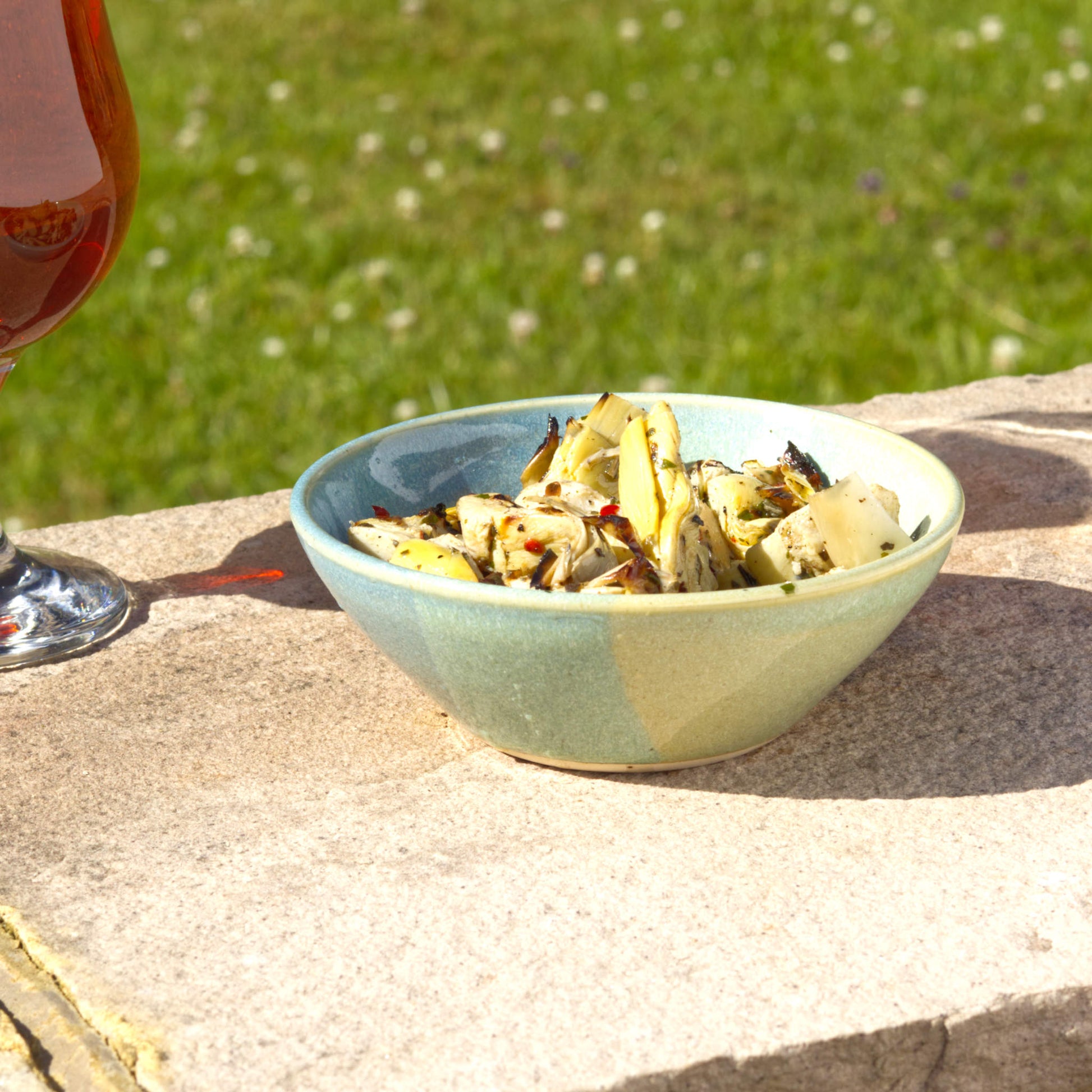 Blue and Green handmade small bowl filled with marinated artichokes, a wheel-thrown stoneware tapas bowl for antipasti, nibbles and relaxed outdoor dining
