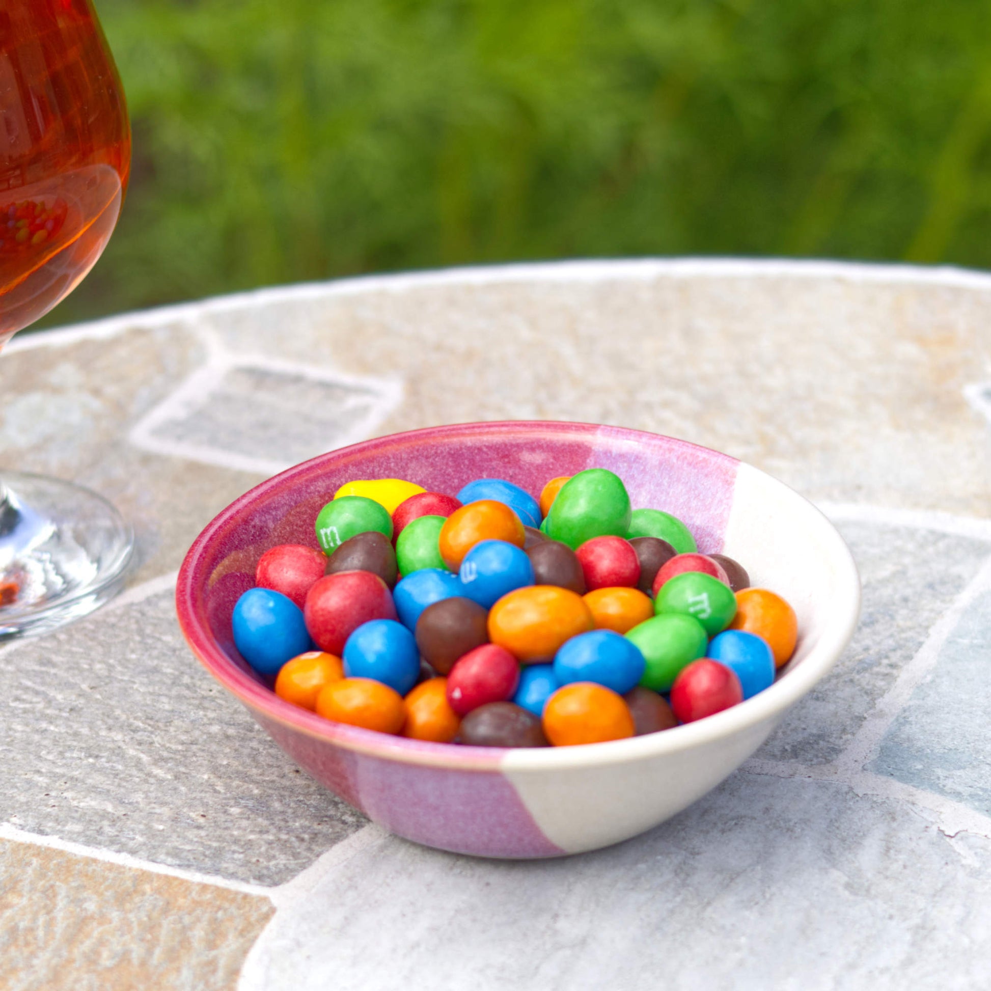 Crimson and White handmade small bowl filled with colourful chocolate sweets, a wheel-thrown stoneware snack bowl for treats, party nibbles and playful table styling