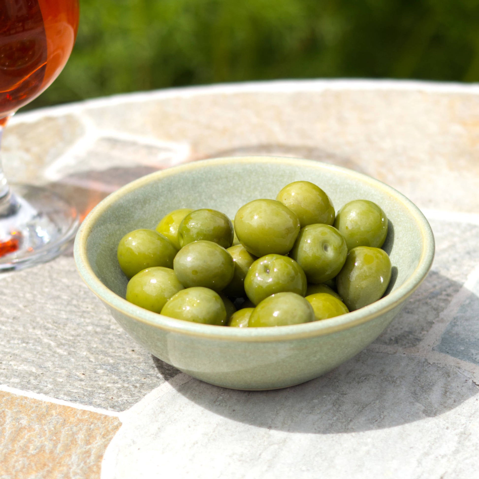 Pale Green handmade ceramic snack bowl filled with olives beside a drink, small pottery bowl for relaxed outdoor nibbles