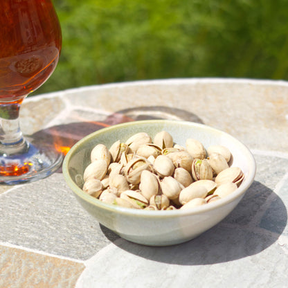 Pale Green and White ceramic nibbles bowl filled with pistachios beside a drink, a handmade snack bowl for barbecues, sharing platters and garden 