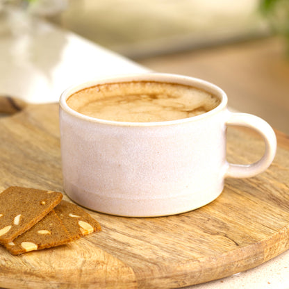 White handmade cappuccino cup filled with coffee, elegant ceramic cup for slow mornings and the smell of fresh beans