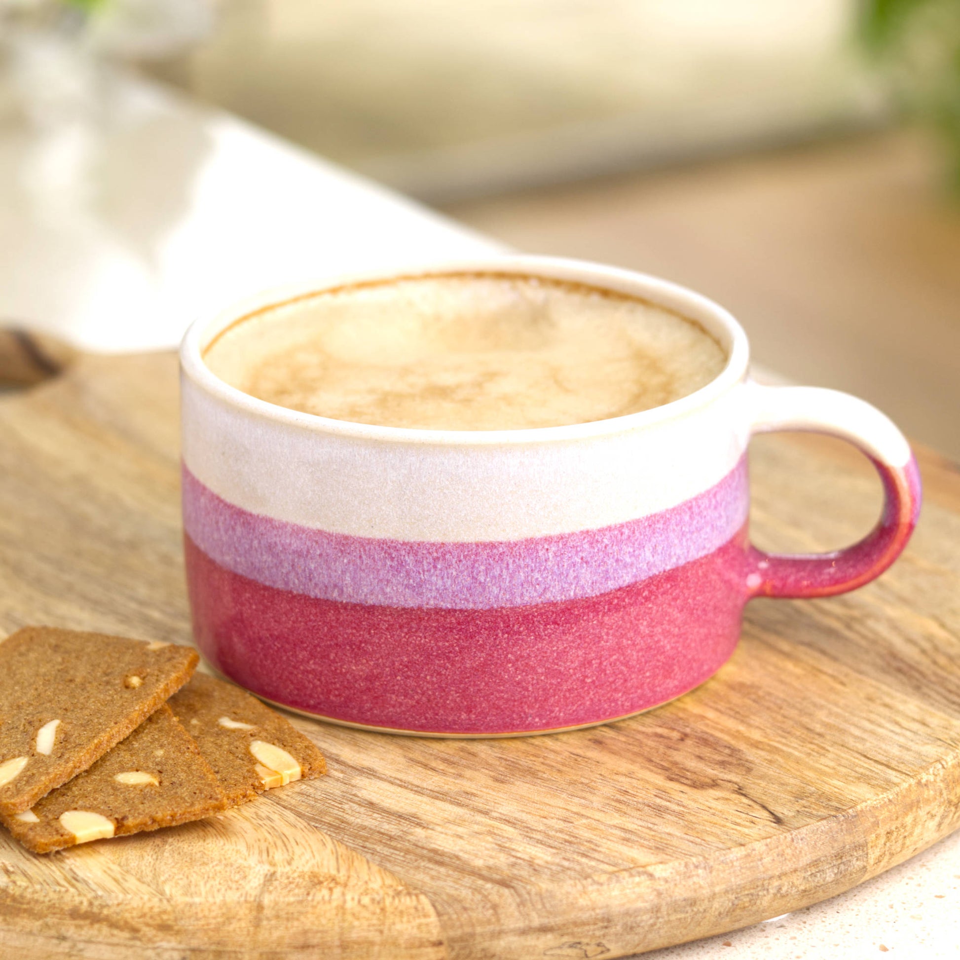 White and Crimson ceramic coffee cup filled with frothy coffee, handmade cup for cosy breakfasts and weekend coffee time