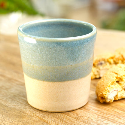 Banded ceramic espresso cup styled in kitchen setting with biscotti for relaxed coffee moment