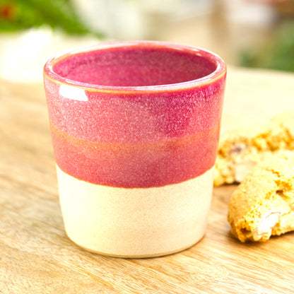 Crimson two-tone espresso cup styled with biscotti for after dinner coffee moment
