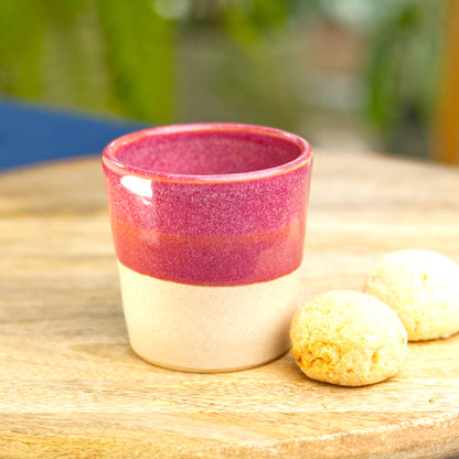 Handmade ceramic espresso cup on table with biscuits for rich evening espresso at home