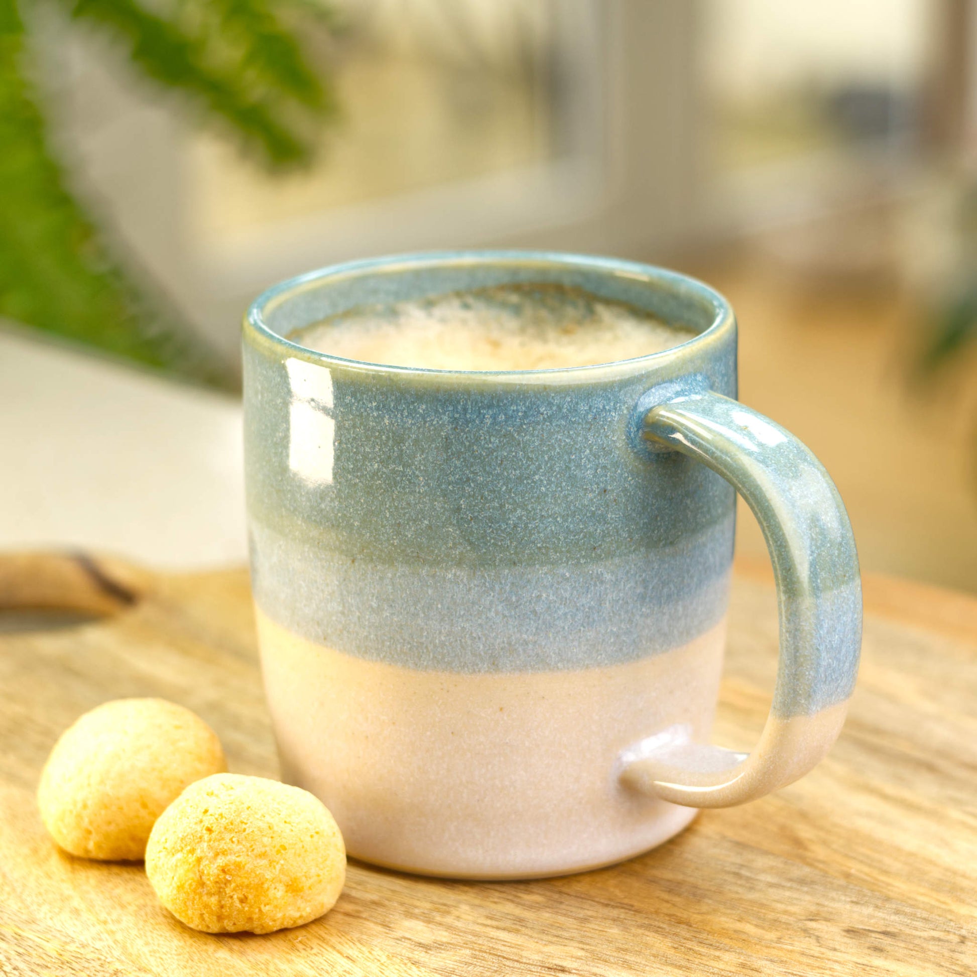 British pottery studio mug in Coastal Blue and White, styled with amaretti for coffee or tea at home