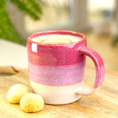 Crimson and White handmade mug filled with frothy coffee on a wooden board, artisan pottery from my small home studio