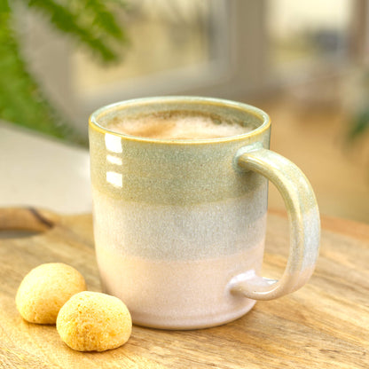 Pale Green and White stoneware mug filled with coffee, a handmade everyday mug from a small home pottery studio