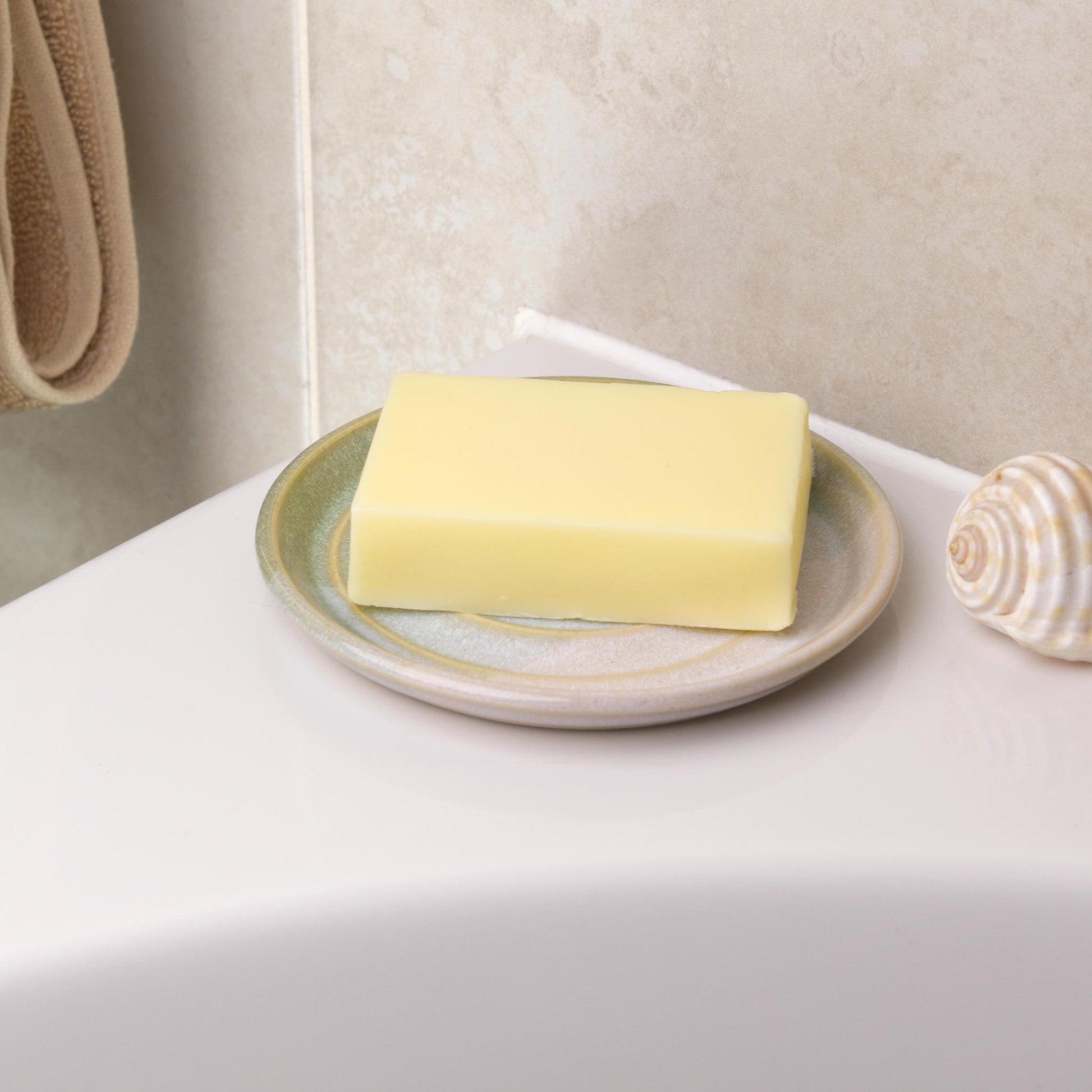 Pale green and white soap saver holding cream soap bar, handmade ceramic bathroom decor with fresh double dipped glaze tones