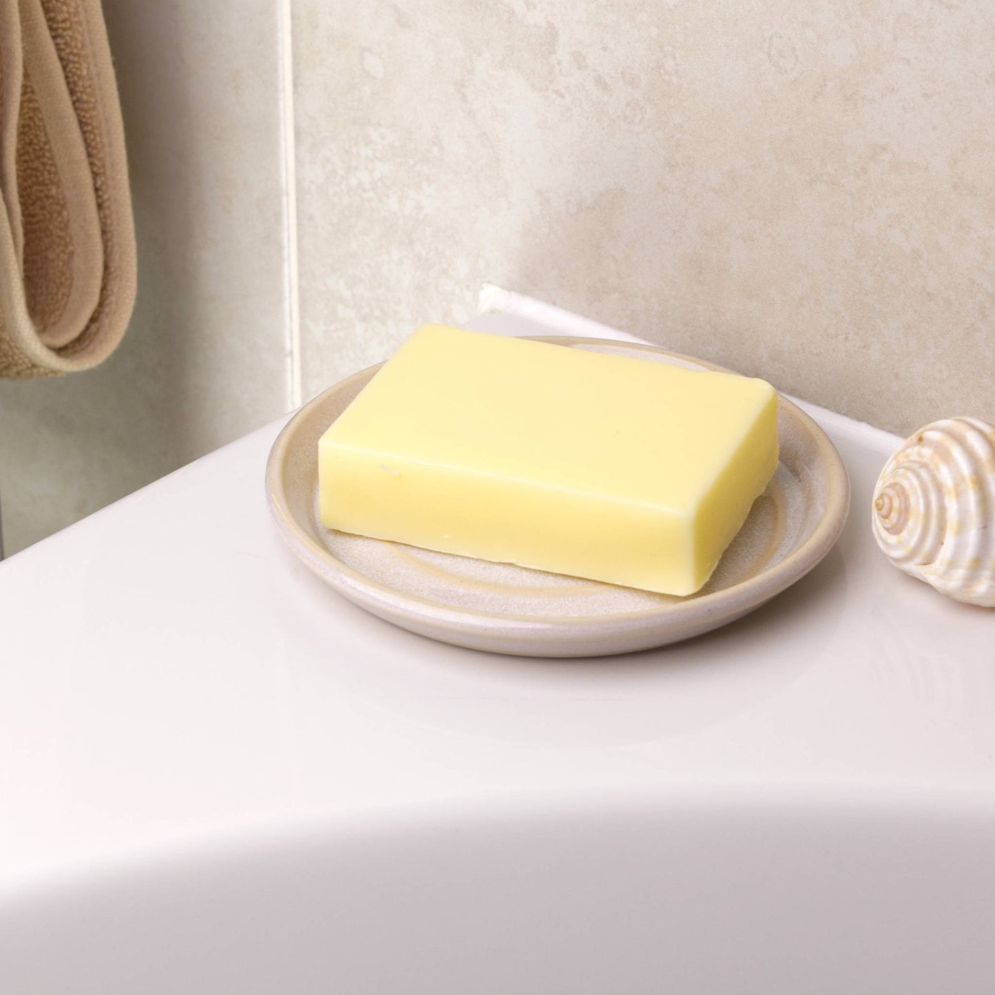 Handmade white stoneware soap dish holding cream soap bar, spiral draining ceramic soap holder for side of bath
