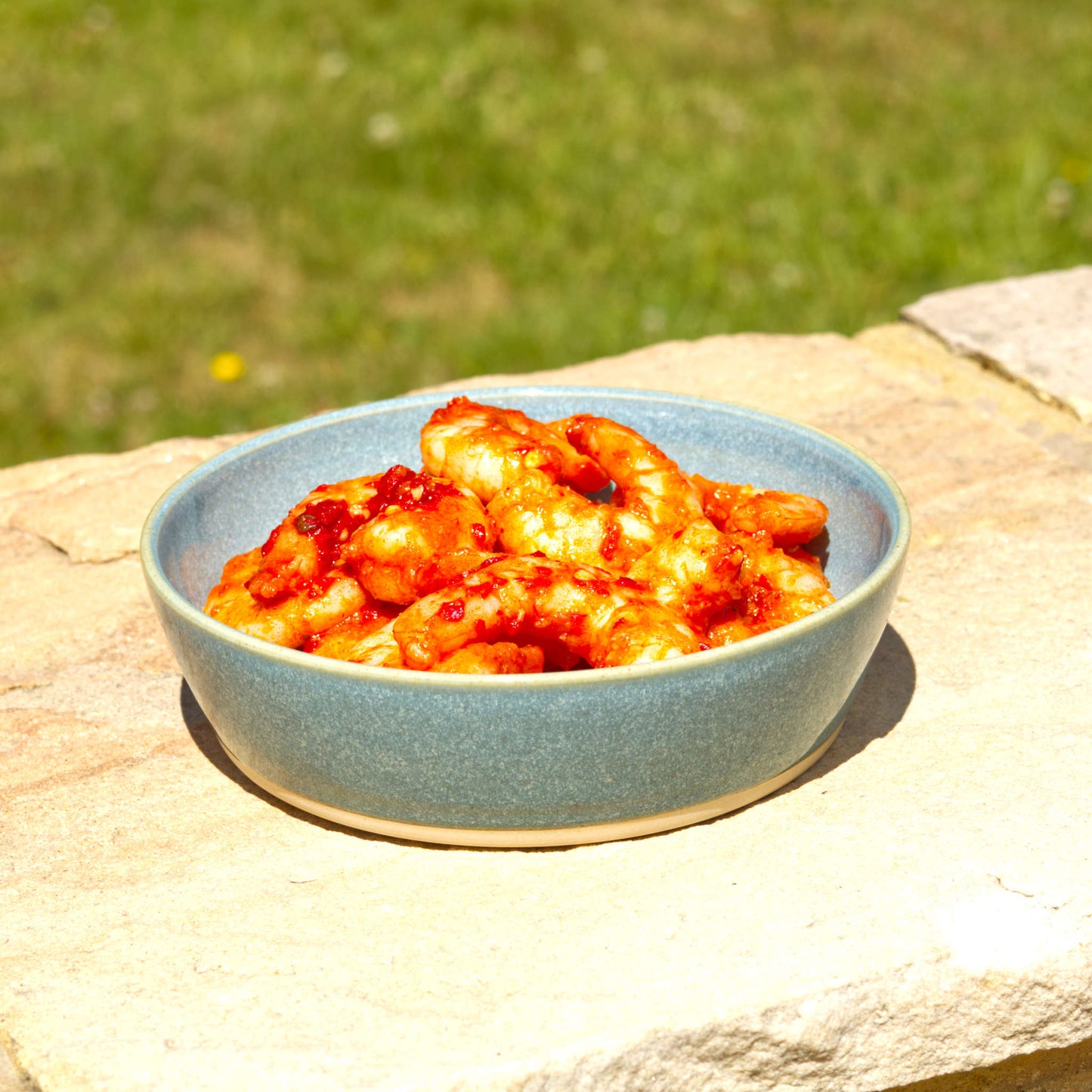 Handmade Coastal Blue ceramic tapas bowl served with prawns, a shallow stoneware dish for seafood starters, small plates and alfresco dining