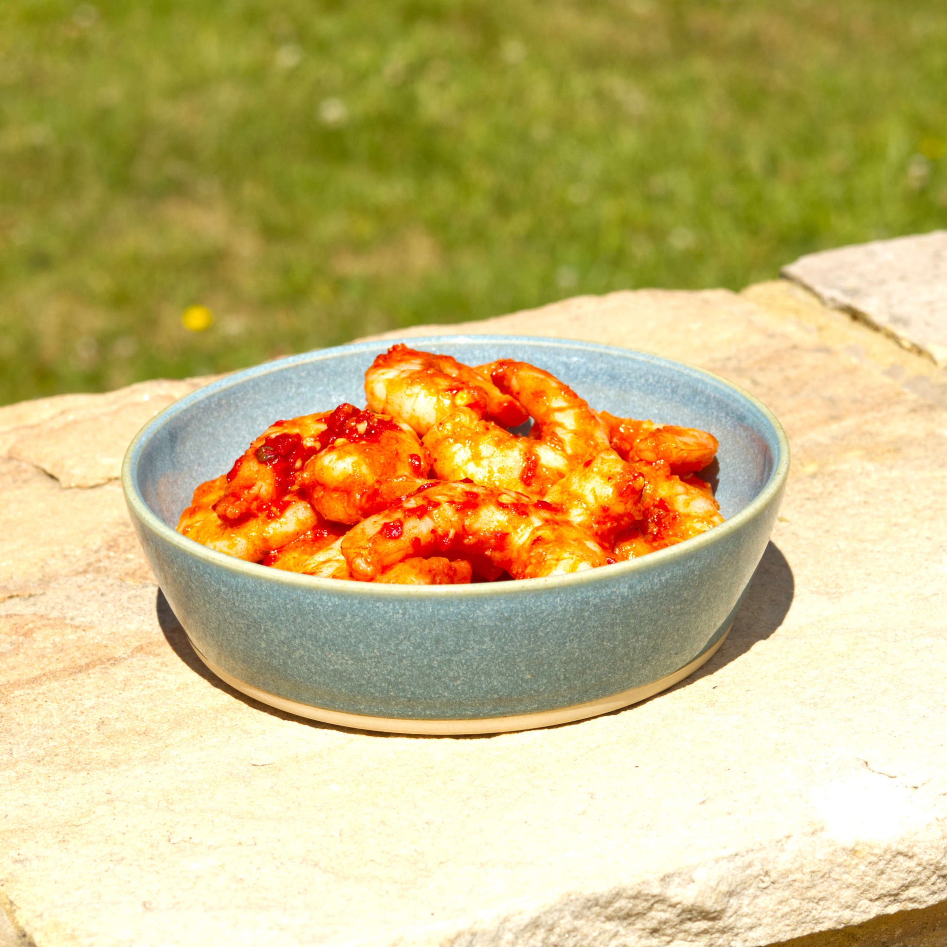 Handmade Coastal Blue ceramic tapas bowl served with prawns, a shallow stoneware dish for seafood starters, small plates and alfresco dining