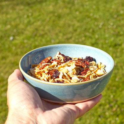 Coastal Blue stoneware tapas bowl held in the hand and filled with granola, ideal for light breakfasts, brunch, yoghurt bowls and outdoor eating
