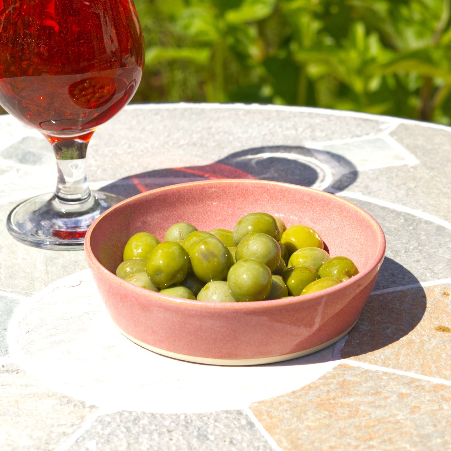 Coral stoneware tapas bowl served with olives beside a drink, ideal for antipasti, mezze, Mediterranean nibbles and alfresco entertaining