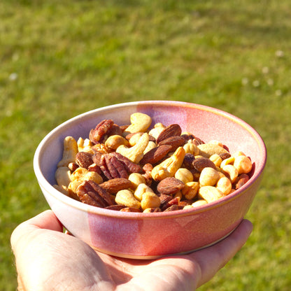 Coral & White handmade tapas bowl held in the hand and filled with mixed nuts, ideal for party nibbles, grazing boards, aperitif snacks and relaxed outdoor entertaining