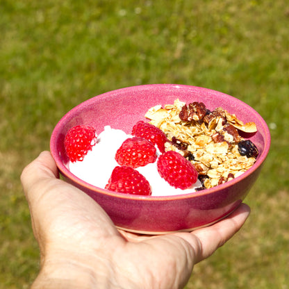 Crimson stoneware tapas bowl used for yoghurt, granola and fresh raspberries, ideal for light breakfasts, brunch and outdoor summer eating