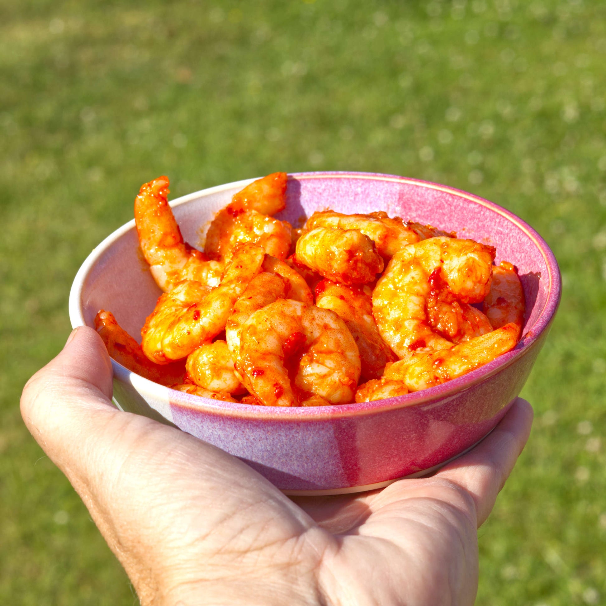 Handmade Crimson & White ceramic tapas bowl held in the hand and filled with prawns, ideal for seafood starters, tapas spreads and summer entertaining