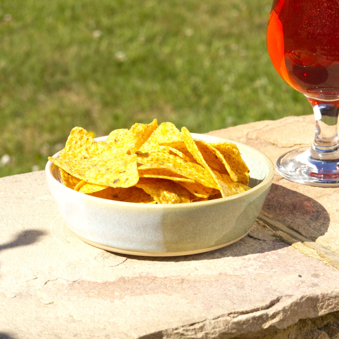 Pale Green & White handmade tapas bowl filled with tortilla chips, styled outdoors for garden entertaining, BBQ nibbles, party snacks and relaxed summer sharing