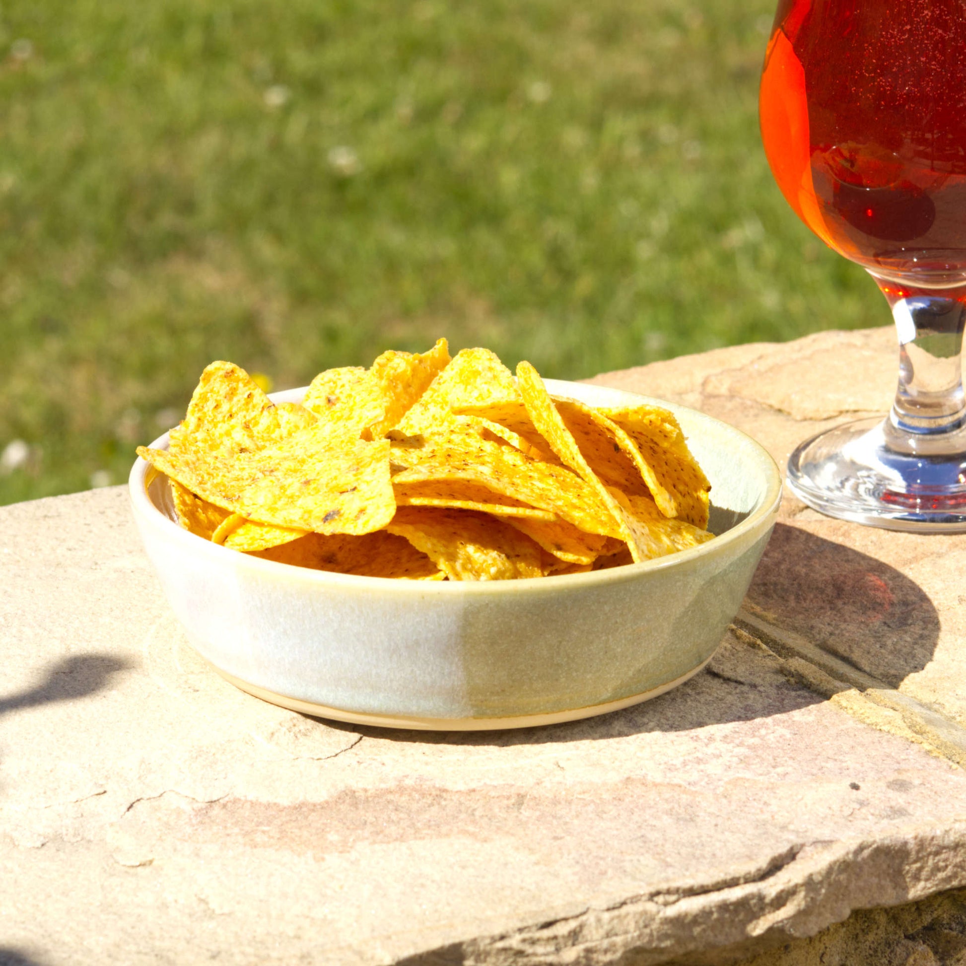 Pale Green & White handmade tapas bowl filled with tortilla chips, styled outdoors for garden entertaining, BBQ nibbles, party snacks and relaxed summer sharing