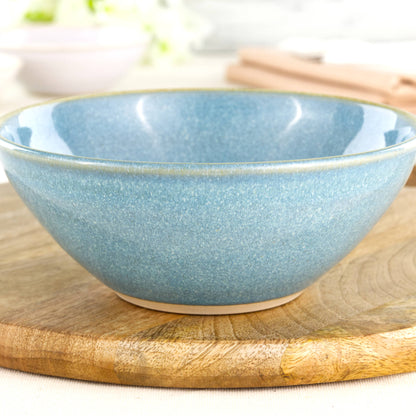 Close-up of a handmade stoneware bowl in Coastal Blue, highlighting the glossy speckled glaze, soft ceramic texture and artisan studio finish