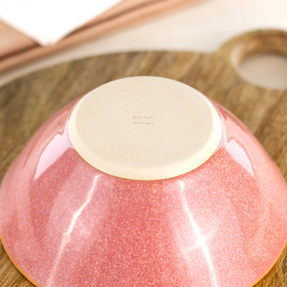 Base of a handmade ceramic bowl in Coral, featuring the D Mack Ceramics makers mark and a smooth burnished underside to help protect wooden and stone surfaces