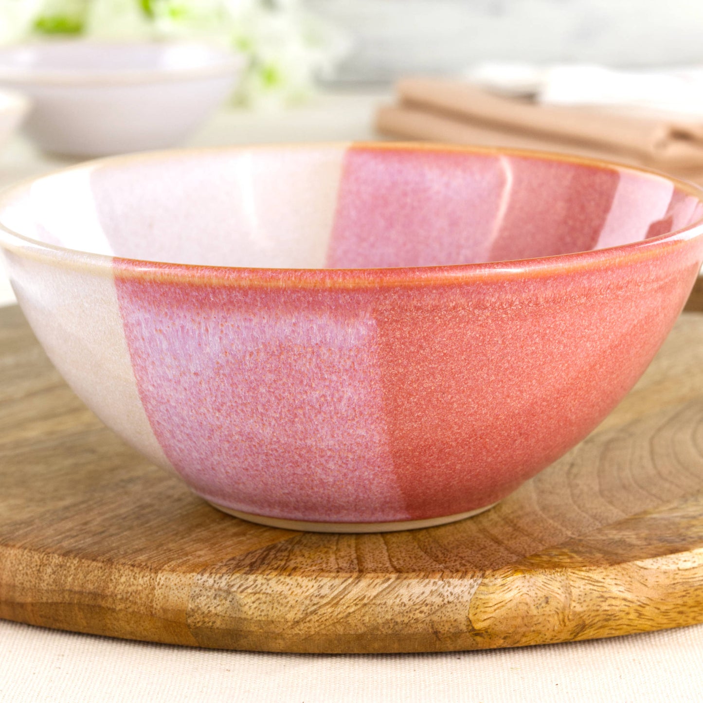 Close-up of Coral and White double-dipped Sea Smoothed Pebble glaze on a wheel-thrown stoneware bowl with warm speckled texture