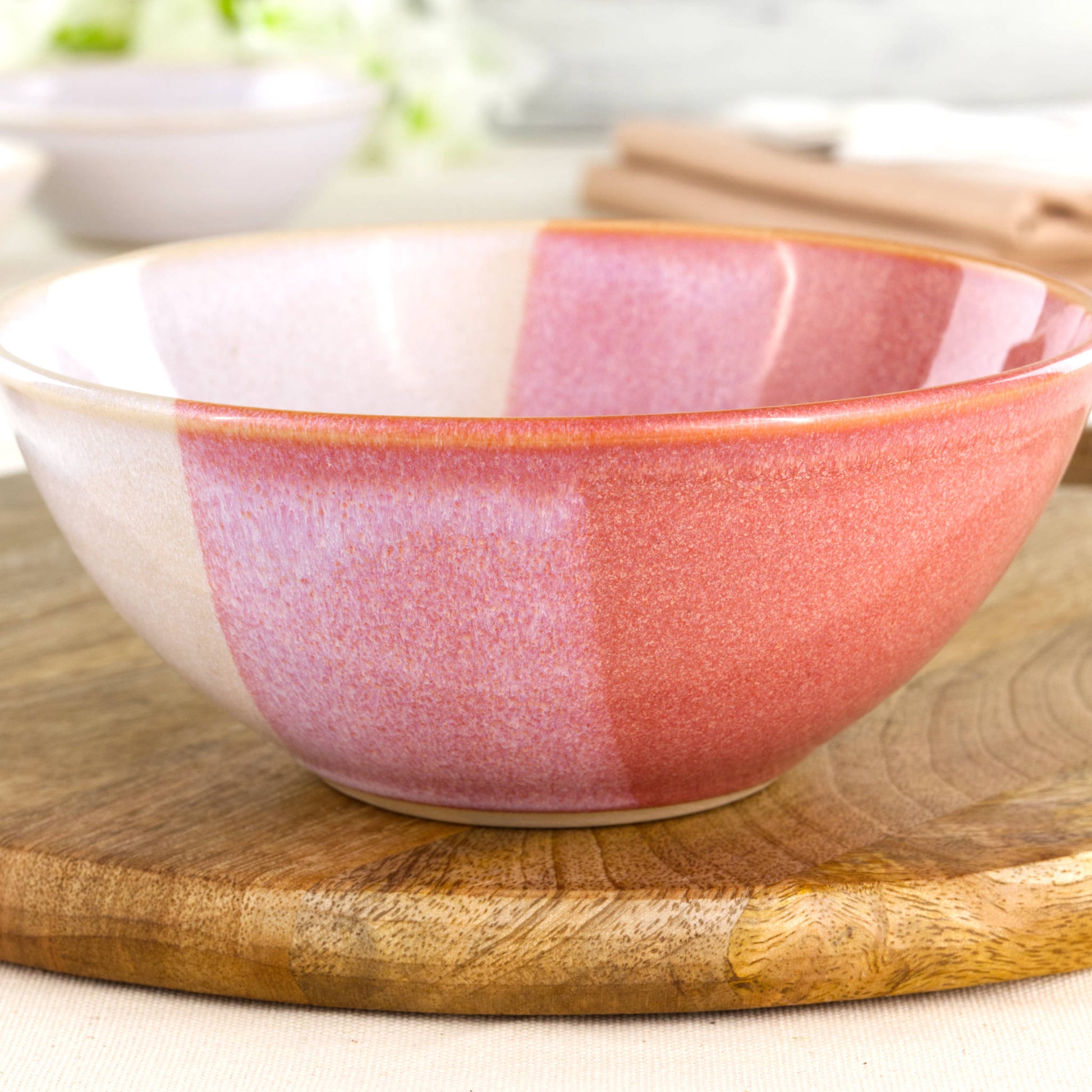 Close-up of Coral and White double-dipped Sea Smoothed Pebble glaze on a wheel-thrown stoneware bowl with warm speckled texture
