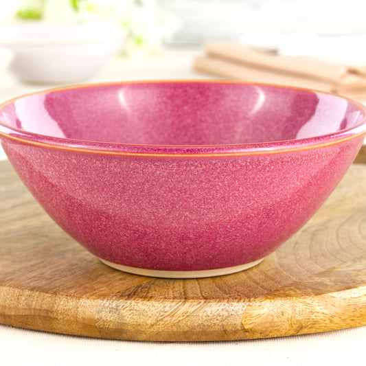 Close-up of a handmade ceramic bowl in Crimson, featuring a rich glossy red glaze, fine speckling and the tactile finish of artisan studio pottery