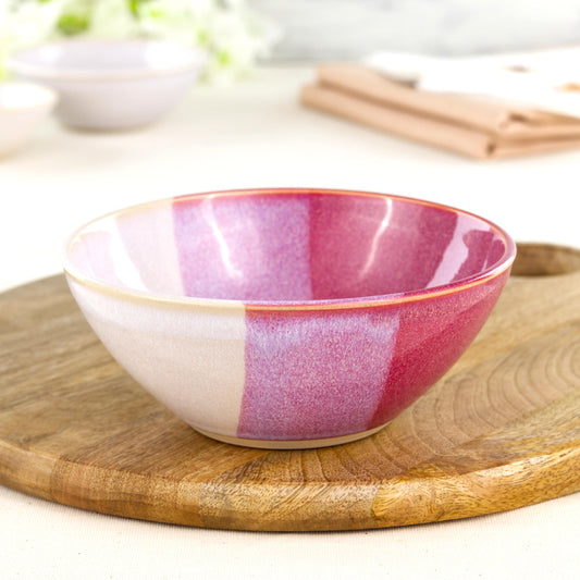 Wheel-thrown medium stoneware bowl in Crimson & White on a wooden board, ideal as a handmade pasta bowl, salad bowl or colourful pottery serving bowl