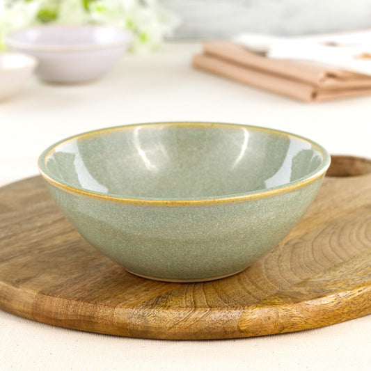Wheel-thrown Pale Green medium bowl on a wooden board, a calm piece of British studio pottery for pasta, salads, serving and relaxed dining