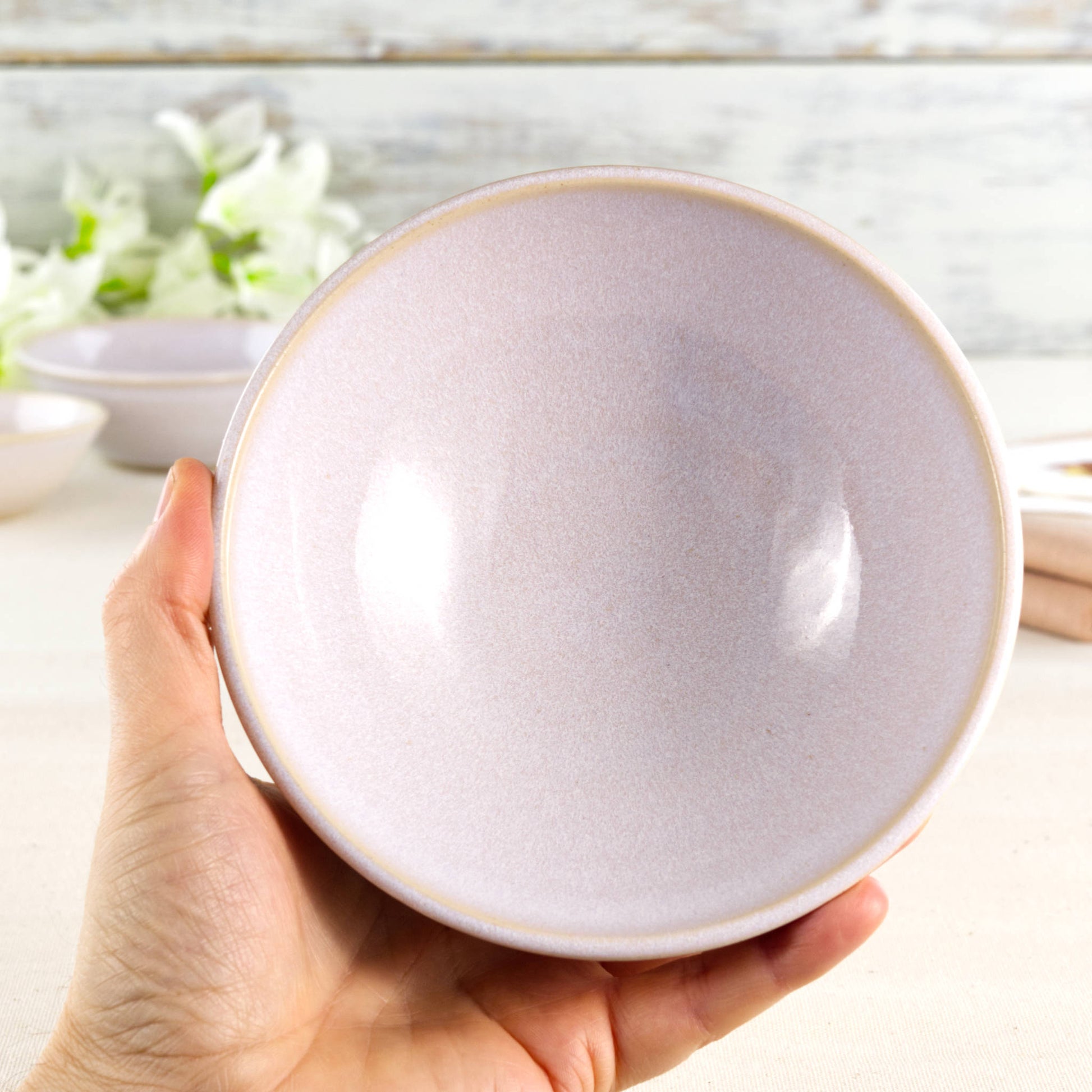 Medium white ceramic bowl held in the hand, ideal for farmhouse kitchens, calm neutral tableware, breakfast bowls, soups or everyday handmade dining