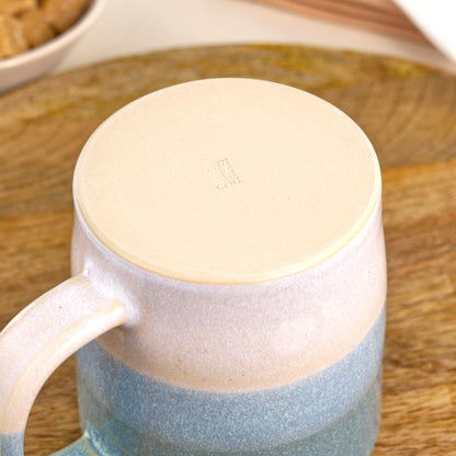 Base of handmade ceramic mug with smooth burnished clay and maker’s mark from a Sussex pottery studio