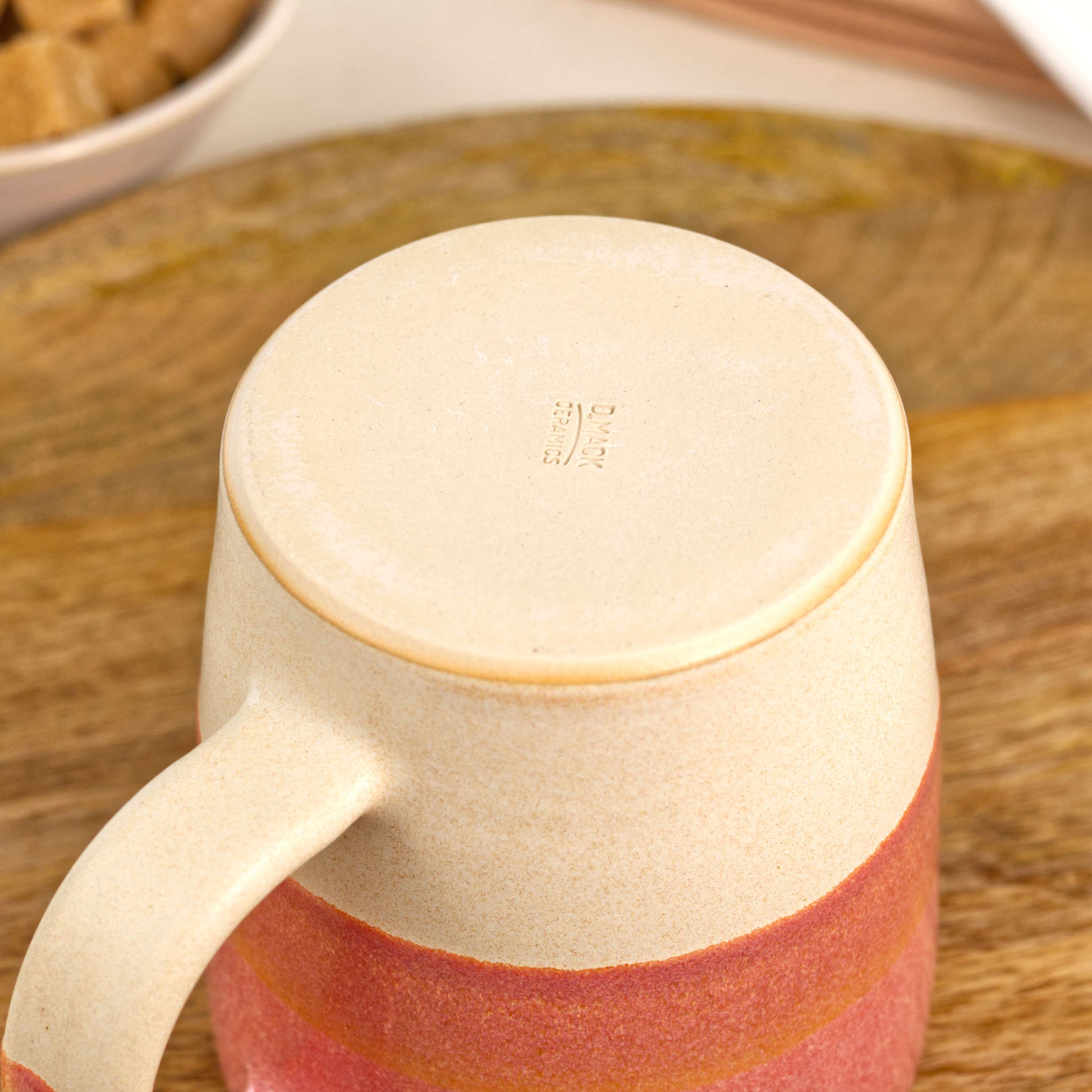 Underside of Coral and Sand ceramic mug showing the burnished smooth base and maker’s mark, handmade in my British pottery studio