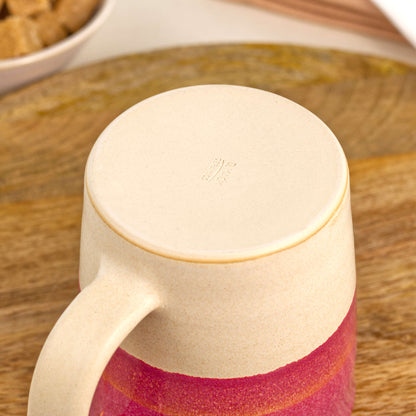 Underside of Crimson and Sand ceramic mug showing the burnished smooth base and maker’s mark, handmade in my British pottery studio
