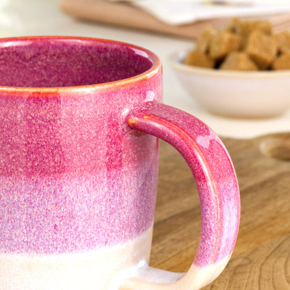 Close-up of the handle and layered Crimson and White glaze on a handmade ceramic mug from my British pottery studio