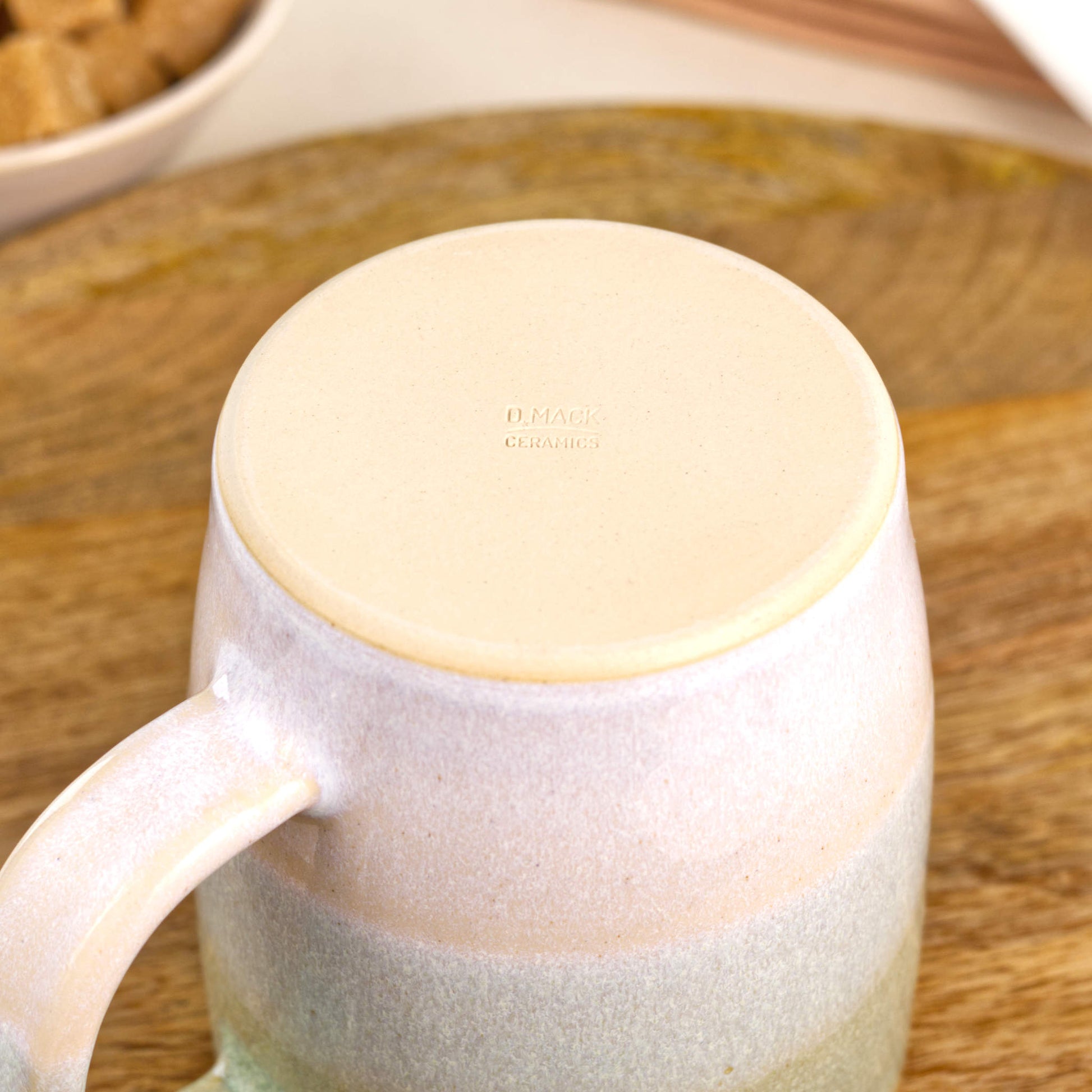 Base of Pale Green and White ceramic mug showing the smooth burnished underside and maker’s mark from my Sussex studio