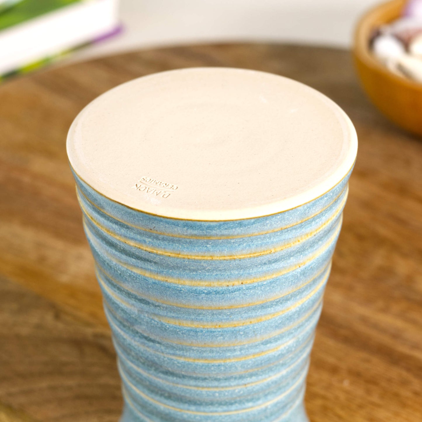 Handmade coastal blue ribbed ceramic bud vase with maker’s mark on base.