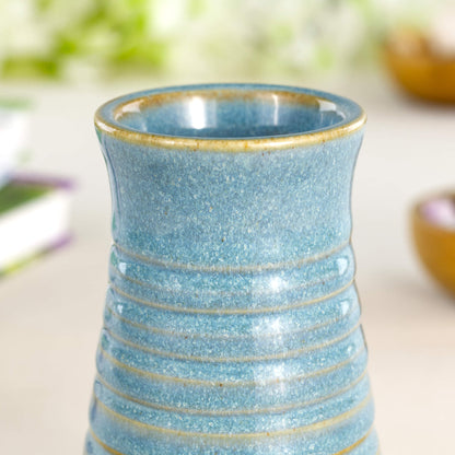 Close-up of coastal blue ribbed ceramic bud vase in Sea Smoothed Pebble glaze with carved grooves.