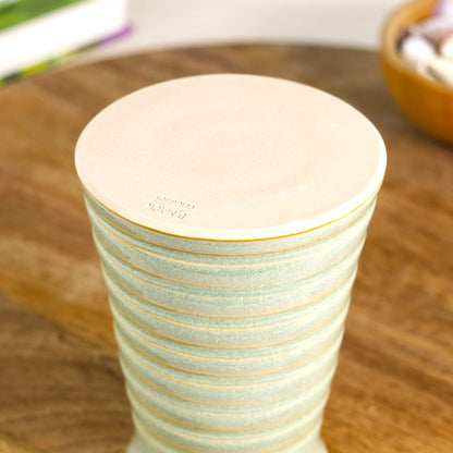 Handmade pale green ribbed ceramic bud vase with maker’s mark on the base, British studio pottery.